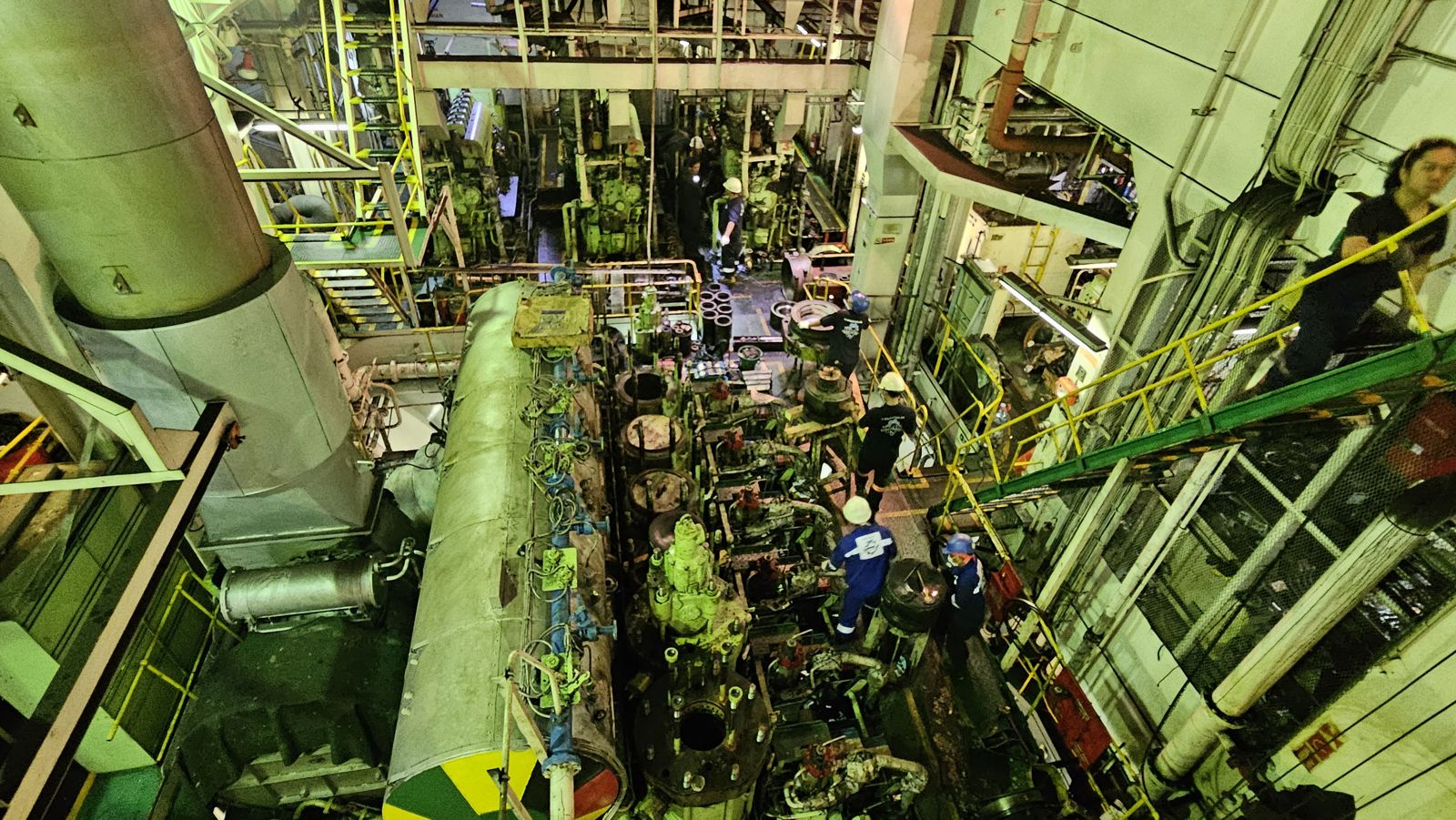 UMJ team working in a vessel's engine room, seen from above