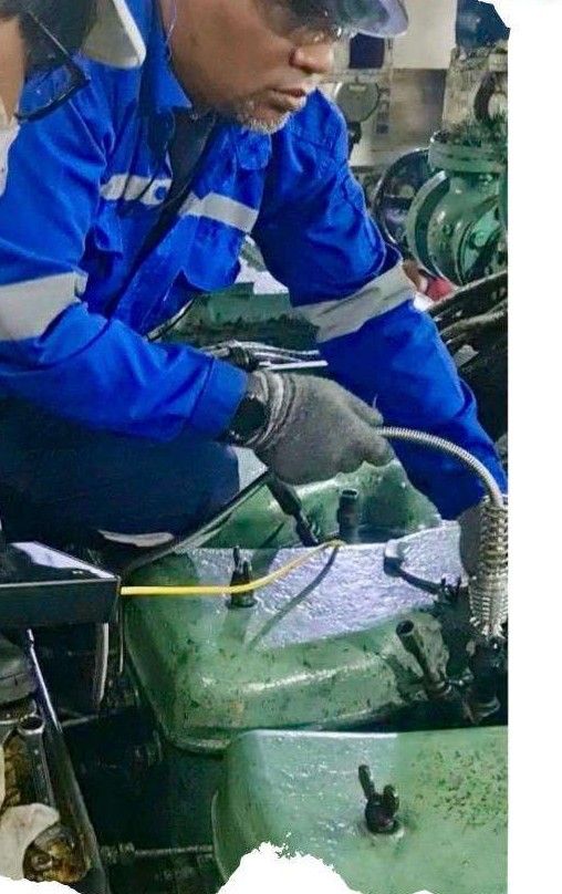 Engineer fitting a pressure sensor to a cylinder indicator valve